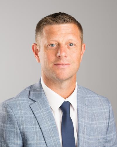 A professional headshot of Dustin Kilgour. 