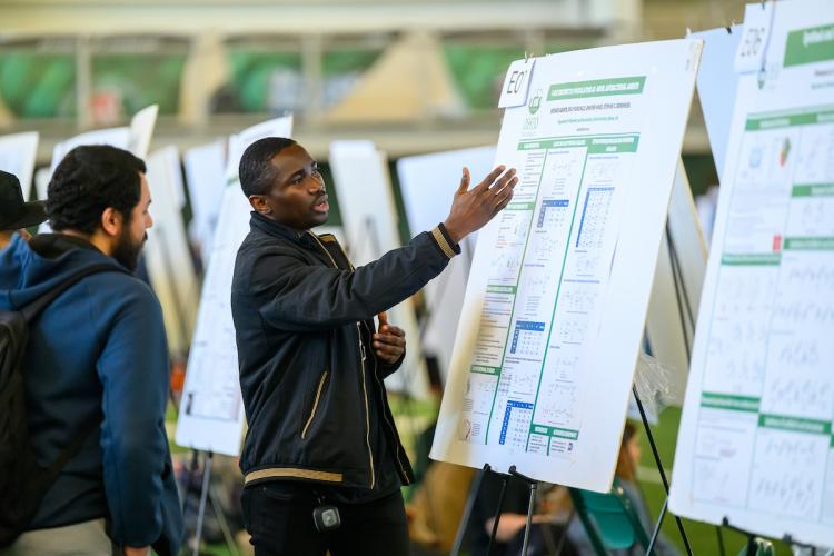 An OHIO student explains a research project at the Student Research Expo