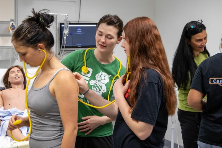 students listen for heart sounds with a stethoscope