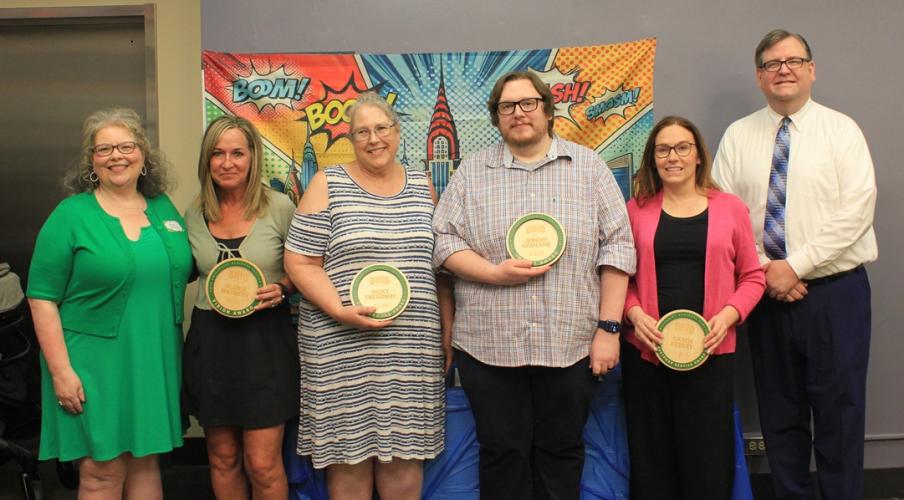 OHIO Business Service Center employees stand together and hold their awards