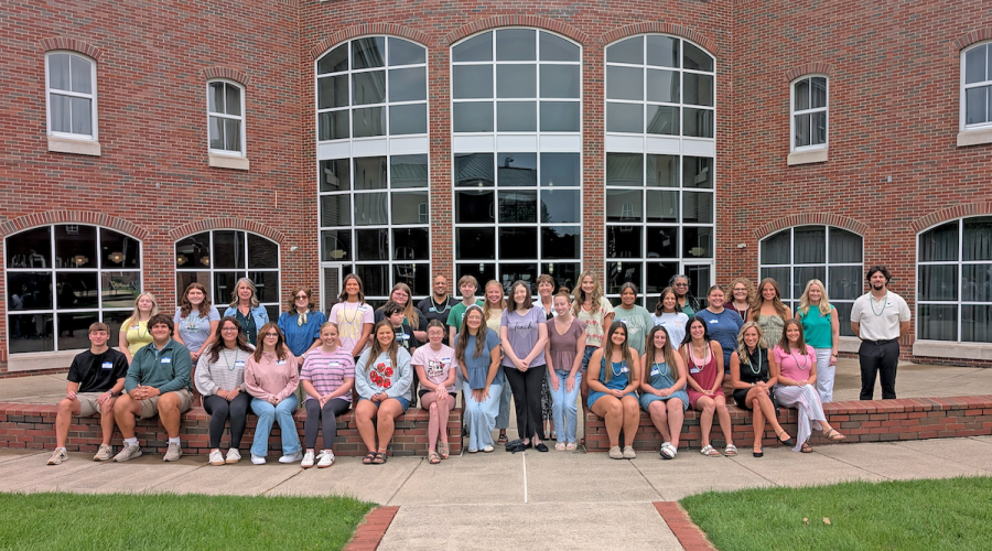 A group of students and faculty and staff stand outside of OHIO Southern