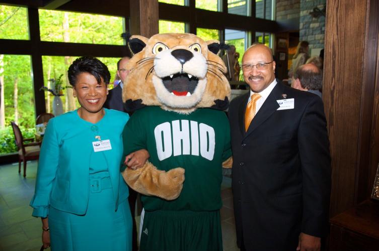Hon. Yvette McGee Brown stands with her husband Anthony Brown and Rufus the Bobcat.