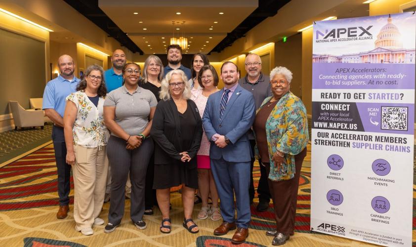OHIO Apex Accelerator representatives are shown at the national conference, and sign for the conference is next to them.