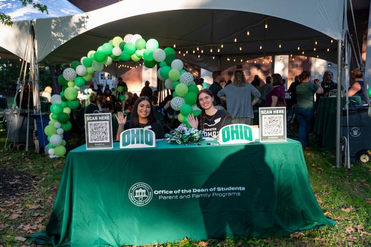 students working check-in table at an Ohio University Family Weekend Event