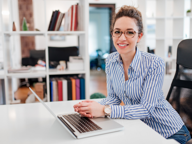 woman sitting at a desk with a computer