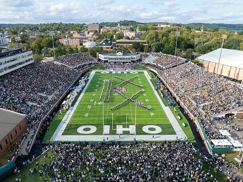 The Marching 110 is shown performing in Peden Stadium