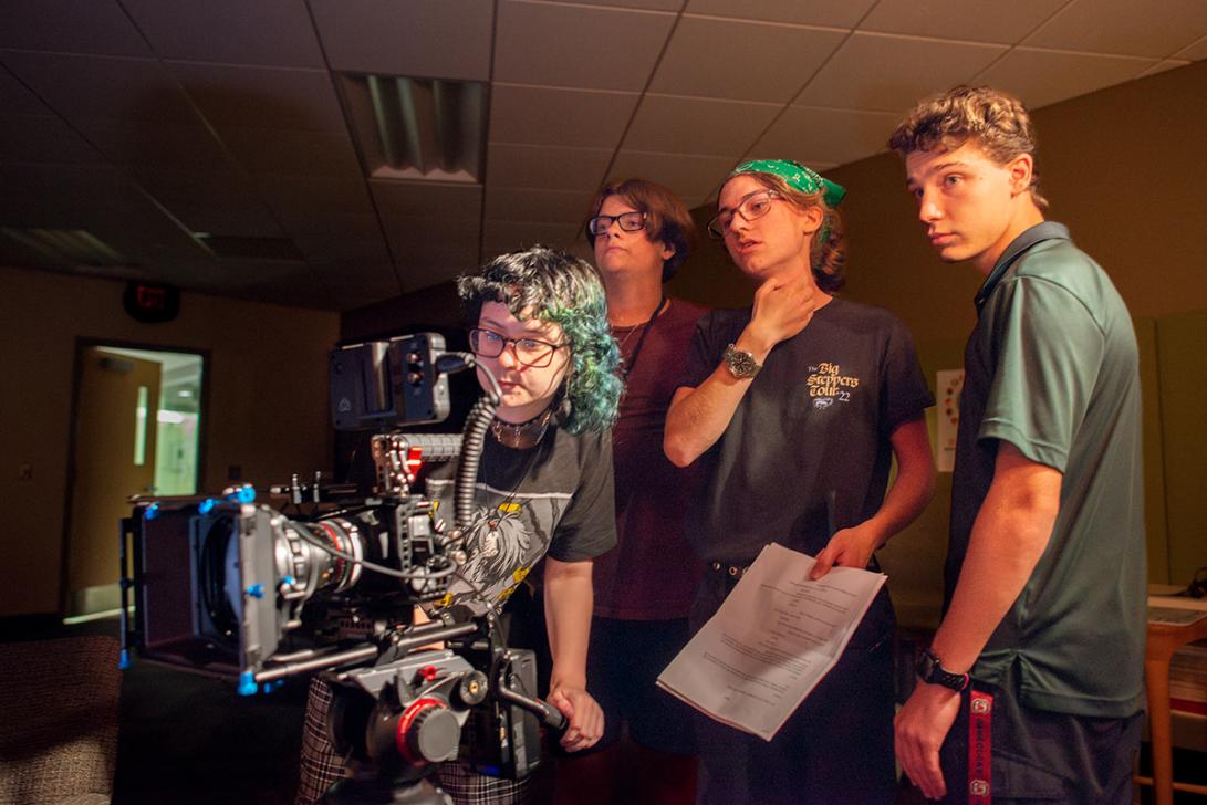 High school students participate in the An instructor and participant set up camera equipment at the 2023 High School Media Workshop