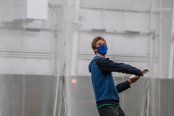 A member of the Men's Ultimate team prepares to throw a frisbee.