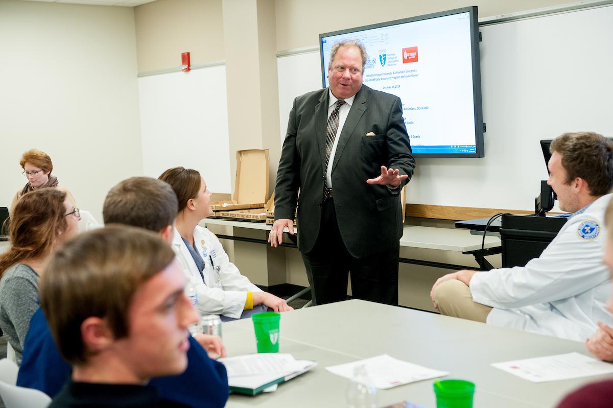 Retired HCOM Admissions Dean John Schriner speaks with students