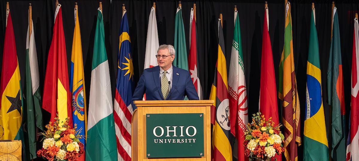 OHIO Provost Don Leo speaks in front of international flags at the 2024 Global Engagement Awards Gala