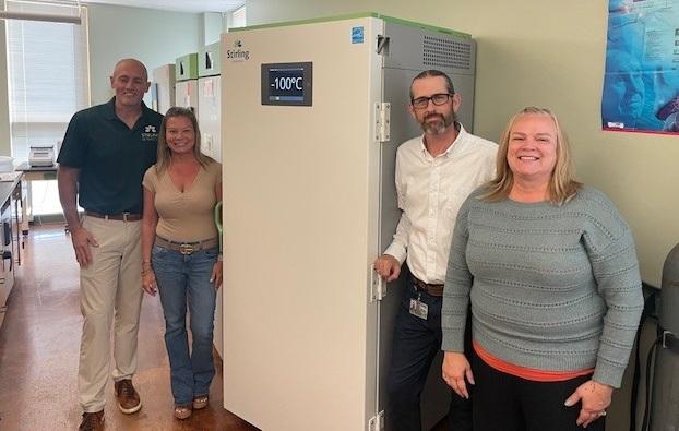 Clayton Newman, Lindsey Denney, Andrew Tucker and Tracey Deal stand in front of the VAULT100 ULT freezer 
