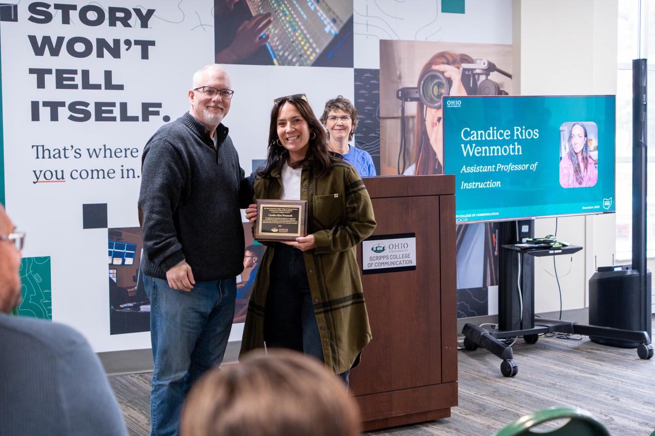 Dean Titsworth hands a plaque to Candice Rios Wenmoth