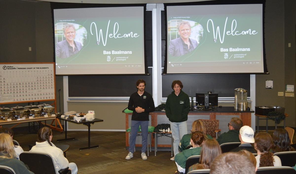 Two OHIO students lead a presentation while the screens behind them say "Welcome Bas Baalmans"