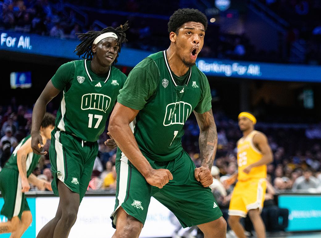 Two OHIO men's basketball players celebrate as play stops.