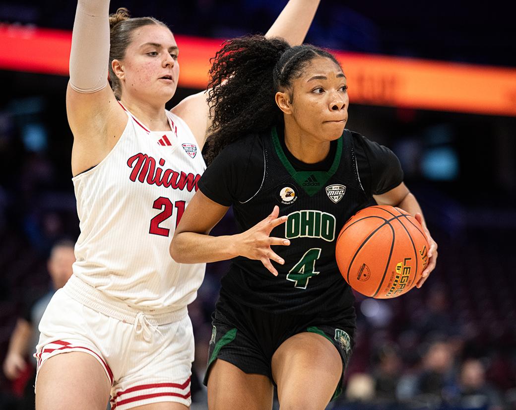 An OHIO women's basketball player is guarded by a Miami player.