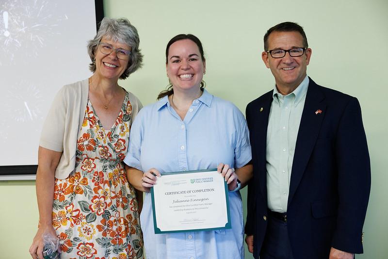 Julie Finnegan, Deanna Clifford and Jay Johnson. Julie  Finnegan holds her certificate