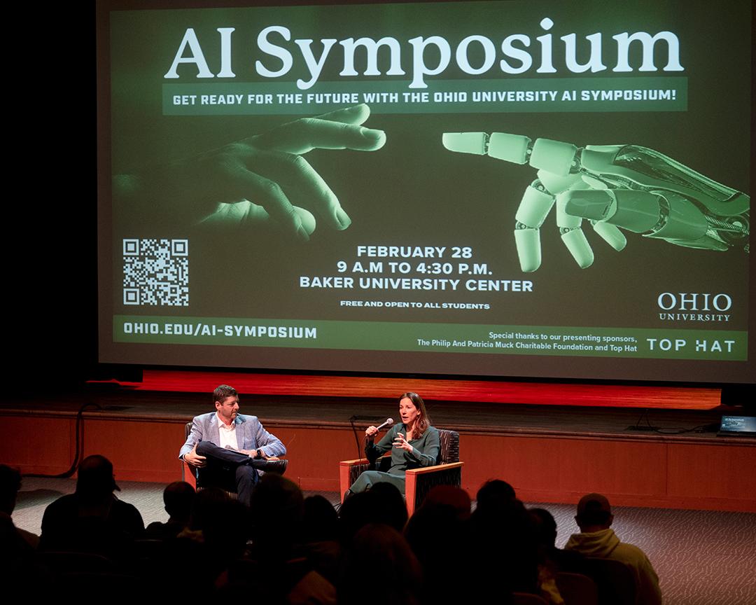 A crowd sits and watches a keynote discussion at Ohio University's AI Symposium.