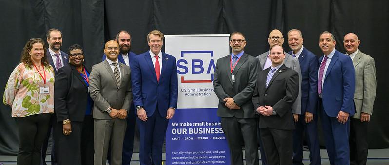 Business leaders and Ohio University representatives stand together for a group image