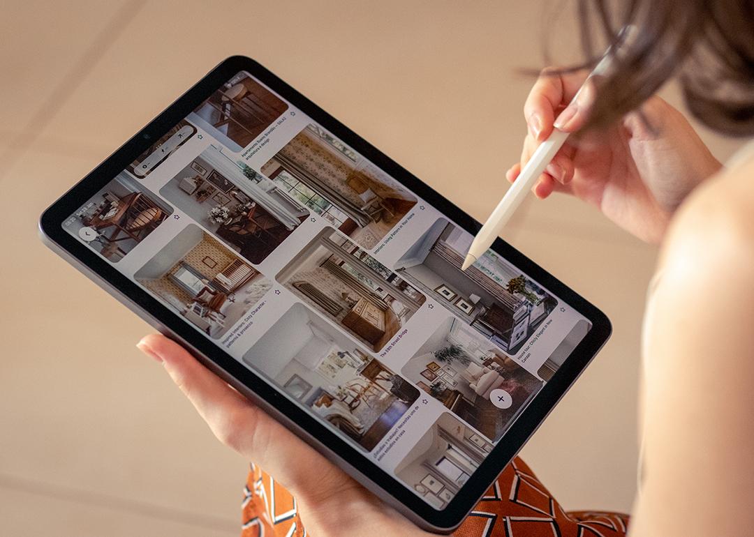 A person scrolls with a stylus on a Pinterest feed.