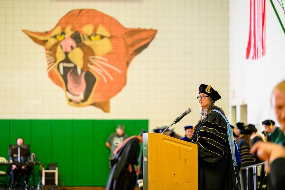 Marth Kline stands at the podium at the Graduation Recogntion Ceremony and gives remarks.