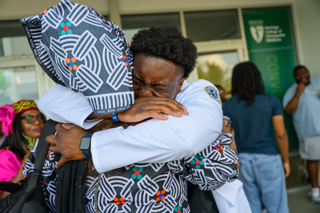 Student hugs family member during HCOM convocation