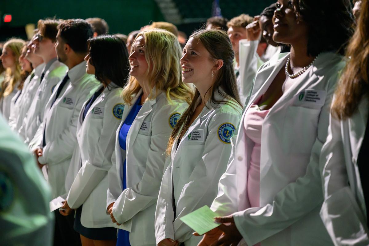 Students smile at family during convocation