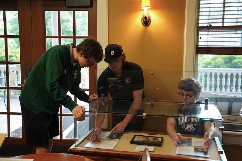 OHIO students work together on one of the displays of the archival materials