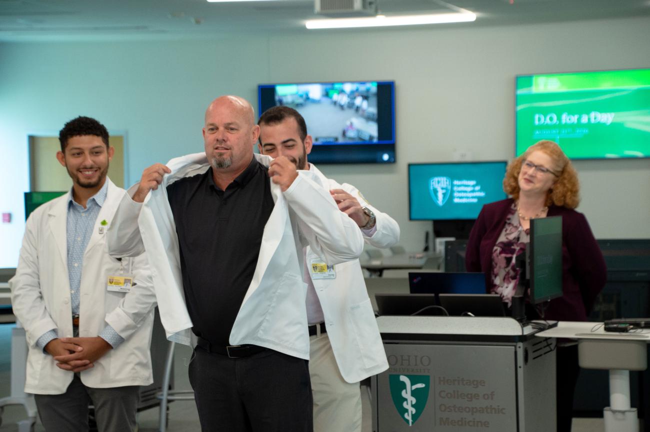 Rep. Ty Moore receives a white coat