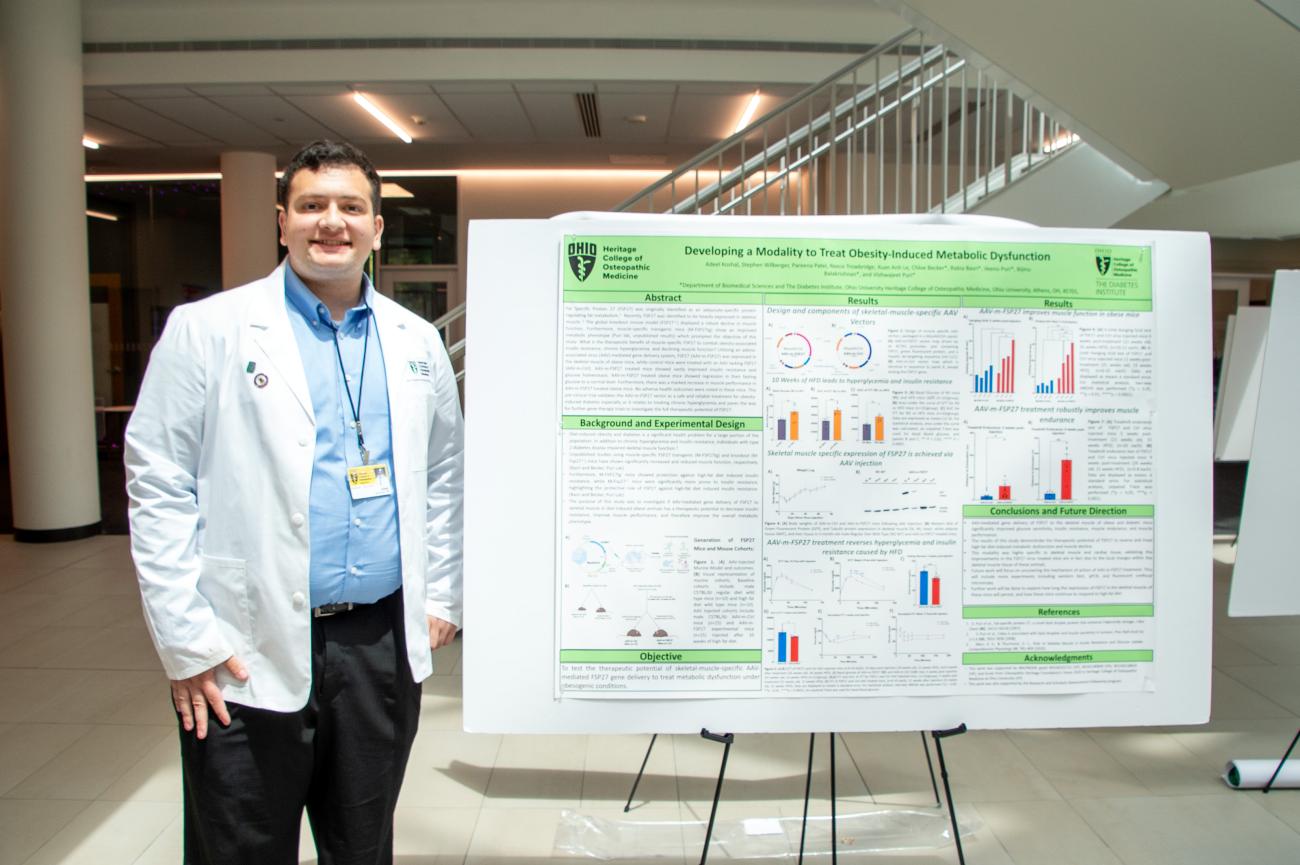 Adeel Koshal, who participated in the RSAF program, stands in front of his research poster