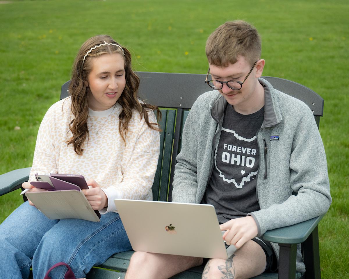 Carly Long seated on a bench next to Gavin Paisley