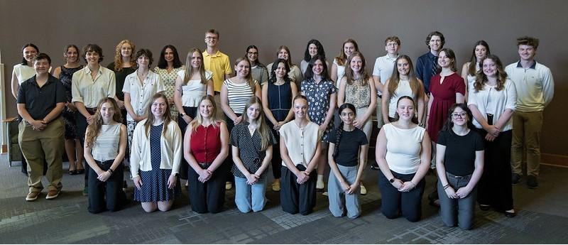 The Undergraduate Research Scholars stand together for a photo at the welcome reception