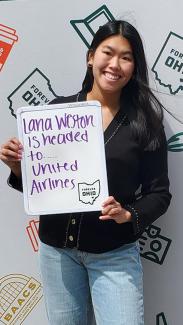 OHIO COB student Lana Weston holding a sign saying she is heading to United Airlines for her summer internship.
