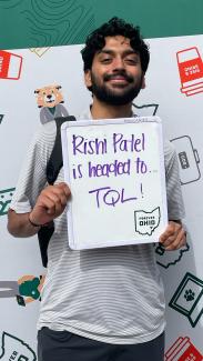 OHIO COB student Rishi Patel holding a sign saying he is heading to TQL for his summer internship.