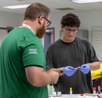 a nursing student works with a high school student