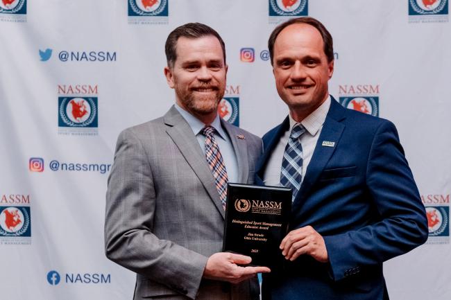Jim Strode accepts award at NASSM conference