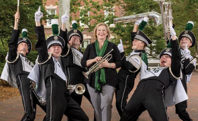Ohio University President Lori Gonzalez poses with members of the OHIO Marching 110 marching band