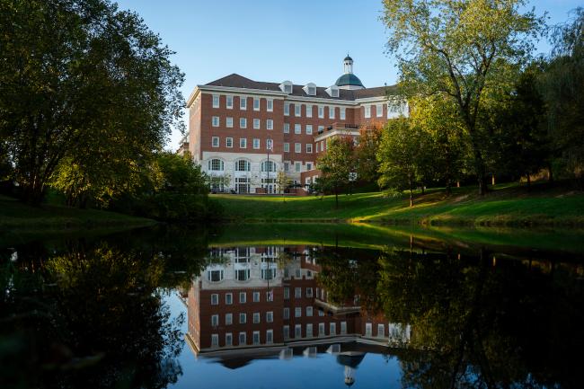 Baker University Center and the pond in front of it. The pond shows a reflection of the building