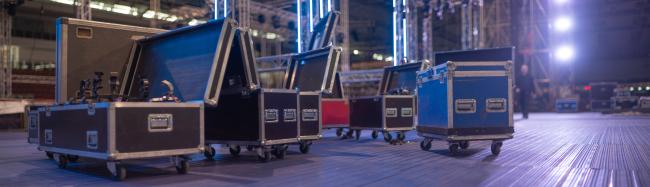 flight cases lined up on a stage in preparation for a live concert