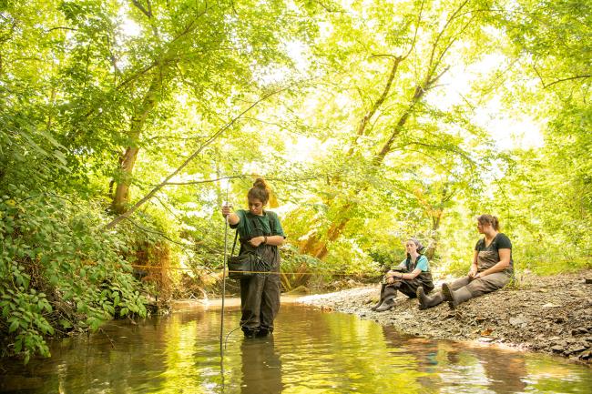 Students with the Voinovich School of Leadership and Public Service test water quality in southeast Ohio.