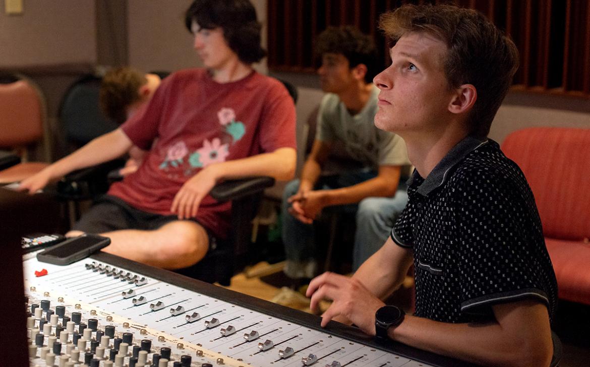 High school students use sound mixing equipment during the 2023 High School Media Workshop