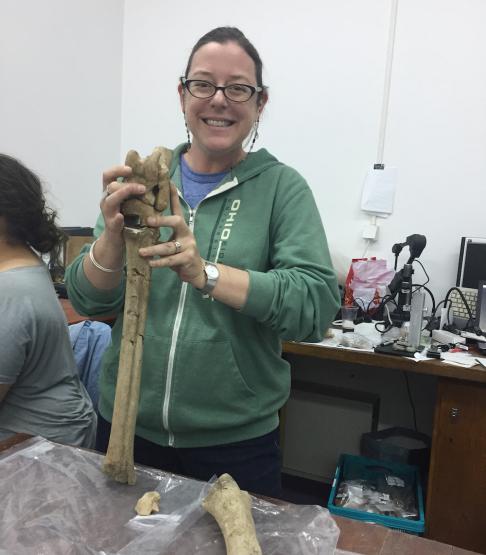 Dr. Sabrina Curran holding giraffe leg bone