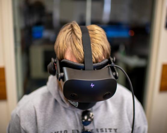 An Ohio University student is shown using virtual reality equipment in the GRID Lab