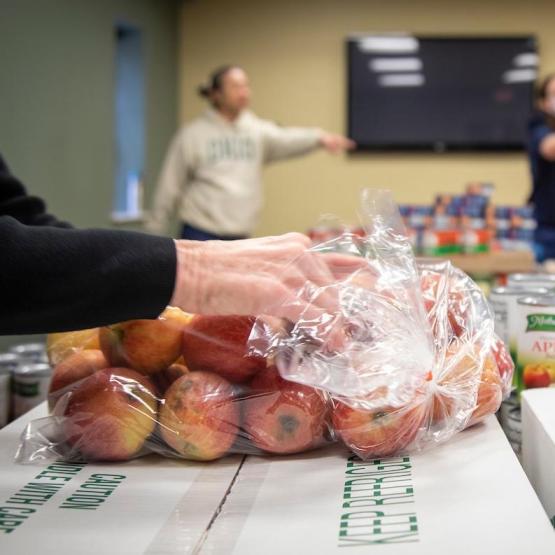 Bags of apples are handed out at a food pantry