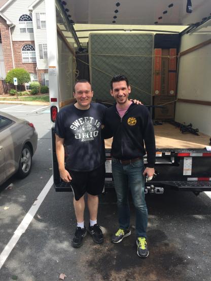 Tony Castricone and Brian Boesch  are shown next to a moving truck in 2017