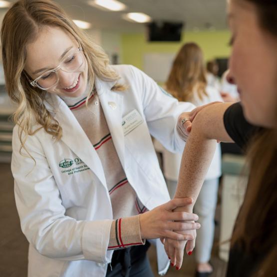 An OHIO medical student performs a medical examination