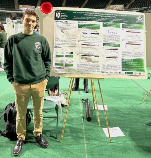 Benjamin Stiadle is shown with his research project at the Student Research Expo