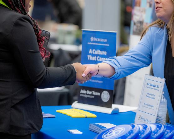 Two people shake hands at an Ohio University Career Fair