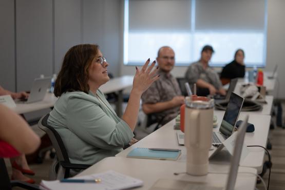 OHIO graduate students discuss a topic in a classroom