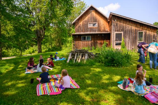 Multiple kids sitting for a picnic at Green Project Camp