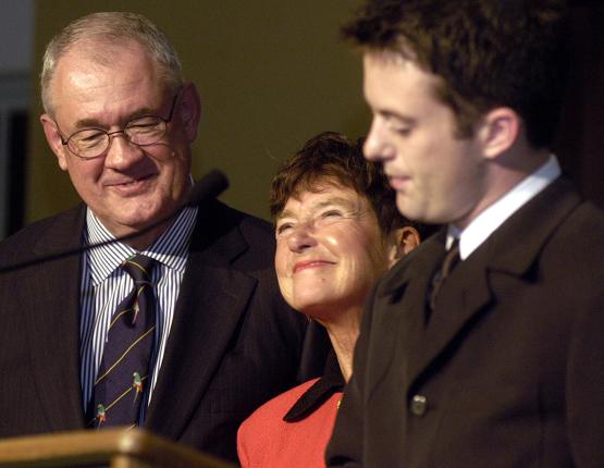 former Ohio University President Robert Glidden and Ohio University Student Trustee Dustin Wood stand at a podium with Jeanette Grasselli Brown between them